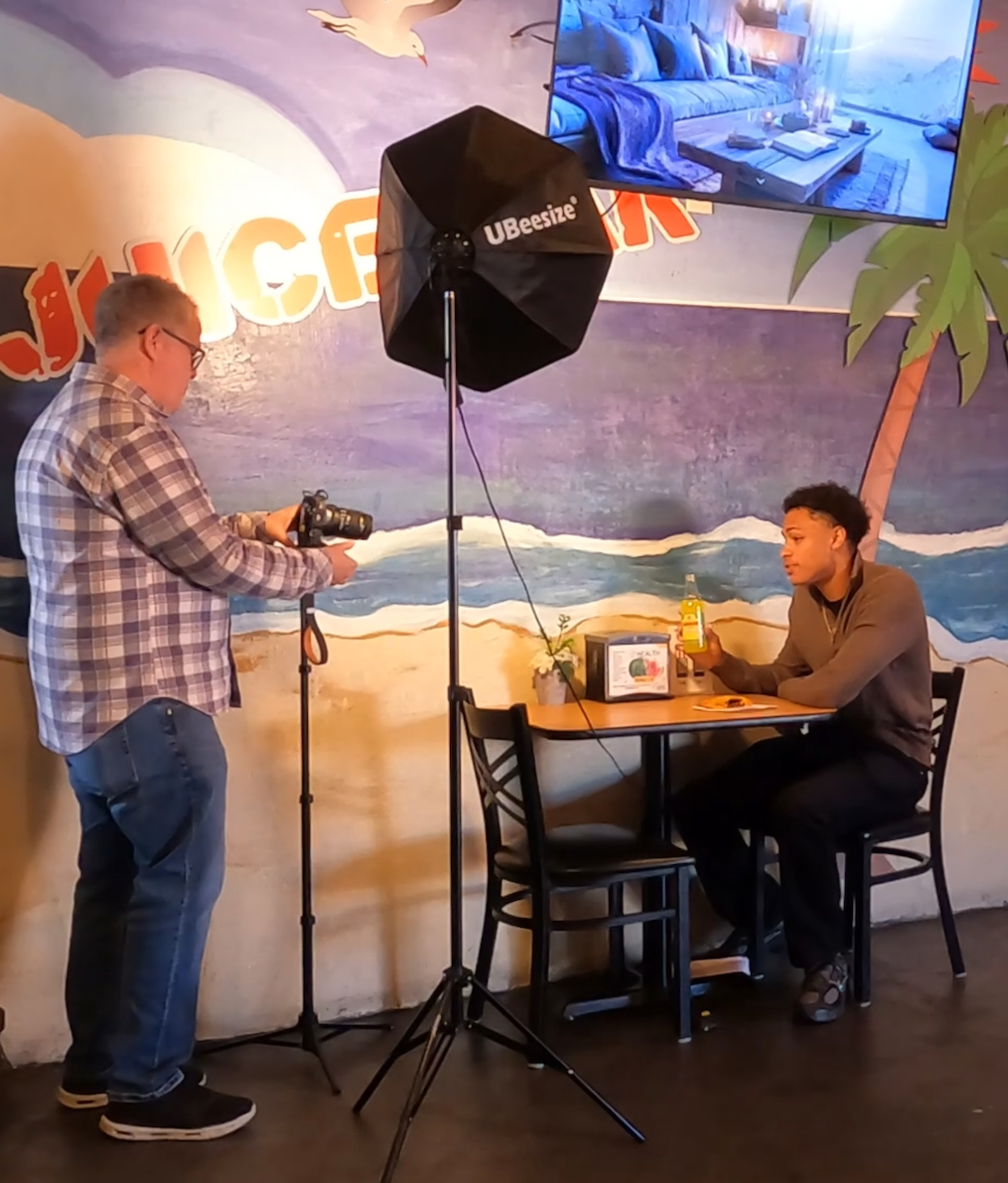 Eric Wein filming restaurant content with a camera and lighting rig